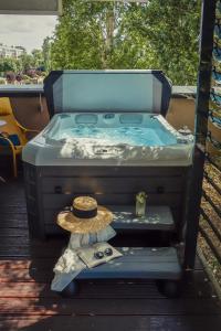 a hot tub with a hat sitting in it at Imola Hotel Plat&aacute;n in Eger