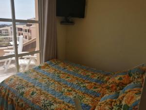 a bed in a bedroom with a view of a balcony at duplex atypique avec magnifique vue mer et baie d'Agay in Saint-Raphaël