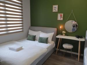 a small bedroom with a bed and a mirror at JK UpperSanctuary 8Pax 3BedR 2BathR 1Carpark in Kuching +47 photos