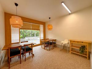 a dining room with a table and chairs and a window at Hotel Ganwoljae in Ulsan