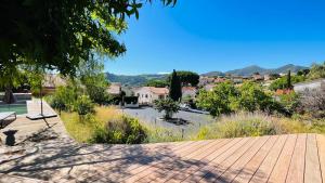 a view of a town from a wooden walkway at 3 pièces avec piscine privative in Collioure
