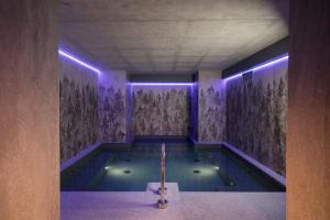 a swimming pool with purple lights in a building at Locanda Bellevue in Pré-Saint-Didier