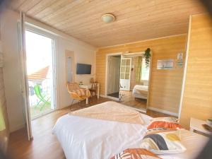 a bedroom with a bed and a room with a window at Hotel de l'Atlantique in La Tranche-sur-Mer