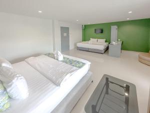 Postel nebo postele na pokoji v ubytování Xanadu Hotel Utapao