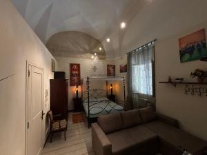 a living room with a couch and a bed at Il Castello te Lu Sannà in Merine