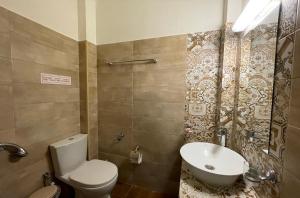 a bathroom with a toilet and a sink at Mariannis Studios in Skala