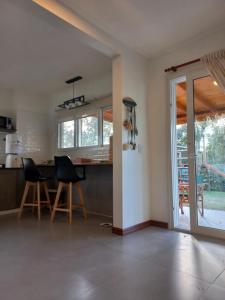 a kitchen with a table and chairs in a room at Espejos de monte in San Miguel del Monte