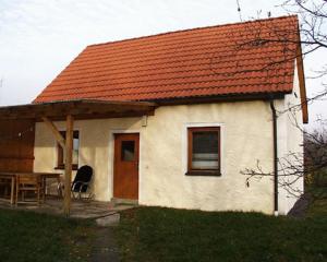 a small white house with an orange roof at Ferienhof Beimler in Waldthurn