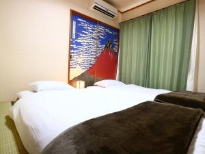 Postel nebo postele na pokoji v ubytování 富士山結アパートメント