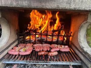 a bunch of sausages and sausage on a grill at Casa Rossa al Lago - Apt Terrazza in Spinone Al Lago