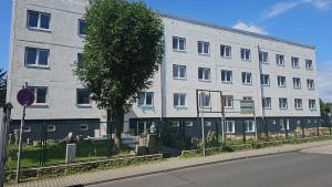 a large white building on the side of a street at Hotel Delisa in Berlin