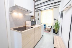 a kitchen with a sink and a microwave at La Cachette d'Amboise - Appart. 2 pers. in Amboise