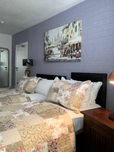 a bedroom with a bed and a picture on the wall at Relax Inn Guest House in Brighton & Hove