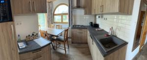 a small kitchen with a sink and a table at Vica Apartman in Balatonberény