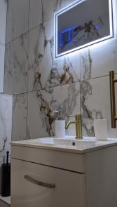 a bathroom with a sink and a mirror at Relax Inn Guest House in Brighton & Hove +85 photos