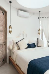 Ένα ή περισσότερα κρεβάτια σε δωμάτιο στο Makaii Tiny Villas with private pools