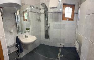 a white bathroom with a sink and a mirror at Vica Apartman in Balatonberény +16 photos