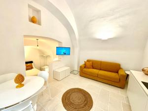 a living room with a couch and a table at Evo Suite & Spa in Vieste