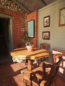 a table with a potted plant and two chairs at Heath Cottage Lower Southrepps north Norfolk in Cromer
