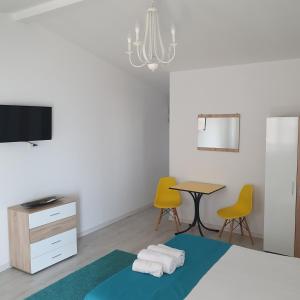 a bedroom with a bed and a table and chairs at Casa Happy in 2 Mai