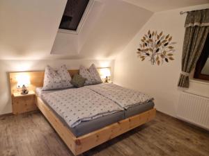 a bedroom with a bed with two night stands and two lamps at Ferienwohnung " Esserhof " Nationalpark Gesäuse in Ardning
