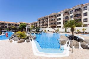 a swimming pool with a slide in a resort at Volcanoes and Ocean Views in Arona