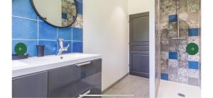 a bathroom with a sink and a mirror and a shower at Gite de groupe La Laiterie in Banneville-la-Campagne +9 photos