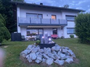 a house with a bunch of rocks in front of it at HausLiebl am Wald in Ruhmannsfelden
