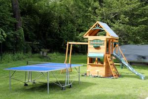a playground with a table and a play structure at Gîte Au Moulin de Bougnon Calme et Dépaysement en Haute-Saône in Bougnon