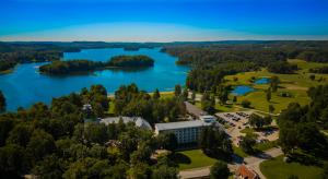 an aerial view of a building next to a lake at Pühajärve Spa & Holiday Resort in Otepää