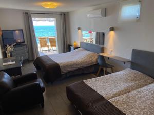 a hotel room with two beds and a view of the ocean at Stella Maris in Hyères