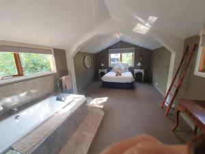 un ampio bagno con vasca e letto di Montrose Barn House- Entire Home a Montrose