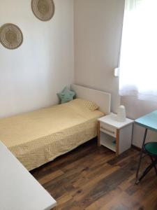 a small bedroom with two beds and a table at La Tournerie de Valis in Clairvaux-les-Lacs