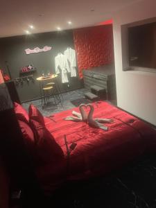 a person laying on a bed in a bedroom at Désirs dune nuit - La séductrice in Cagny