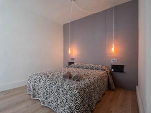 a bedroom with a bed with shoes on it at La Fantástica Pontedeume 2 in Puentedeume