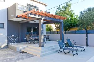 a pergola with chairs and a table on a patio at Holiday house Vito Zadar in Zadar