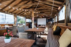 a restaurant with wooden tables and chairs and a screen at The Pilgrim Inn in Southampton