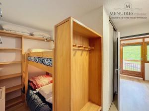 a small room with bunk beds and a door at Studio + cabine 4 pers 24m², ski aux pieds, parking à proximité - FR-1-178-106 in Les Menuires