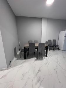 an empty room with a table and chairs in it at Apartments Melina in Korinós