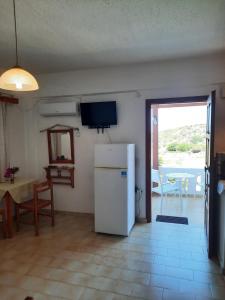 a kitchen with a refrigerator and a table and a door at Victoria2 in Istro