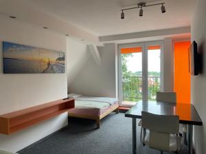a room with a desk and a table and a window at Pokoje centrum in Sopot