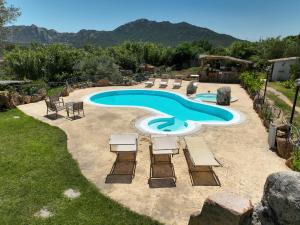 a pool with chaise lounge chairs and a swimming pool at Luxury Home in Porto Rotondo in Cugnana +58 photos
