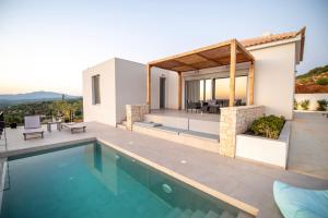 a villa with a swimming pool and a house at Sunset Luxury Villa in Akritokhórion