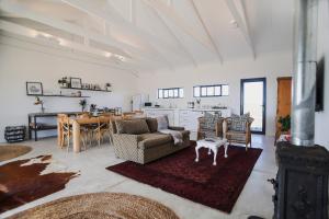 a living room with a couch and a table at Traka Cottage in Klaarstroom