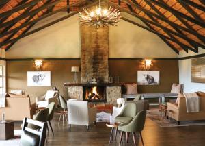 a living room with a fireplace and chairs at Little Switzerland Resort by Dream Resorts in Ethels Drive