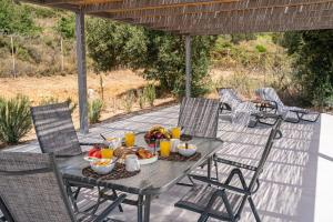a table with food and drinks on a patio at Villa Aionia in Lepeda in Lixouri