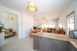 a living room with a kitchen and a dining room at Villa Aionia in Lepeda in Lixouri