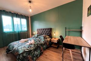 a bedroom with a bed and a table and a desk at Maison 4 chambres Albertville in Albertville