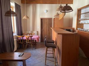 a kitchen and dining room with a table and chairs at Penzión Duna & soľná jaskyňa in Komárno