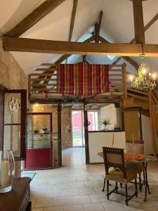 a kitchen with a table and chairs in a room at Chaumière en Brenne in Mauvières +5 photos